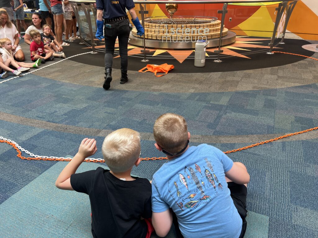 Watching a science demonstration at COSI